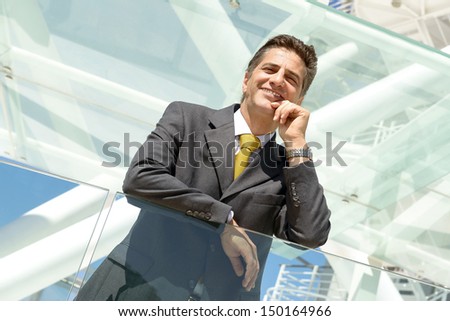 Businessman posing relaxed outdoors in a sunny day