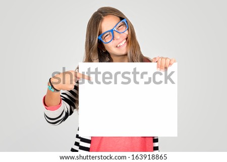 Happy teenager girl with a white board isolated in white