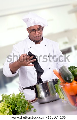Male chef removing a dirty sock from frying pan