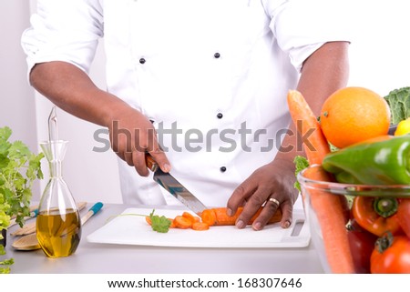 Detail of male chef hands with fruits and vegetables on table
