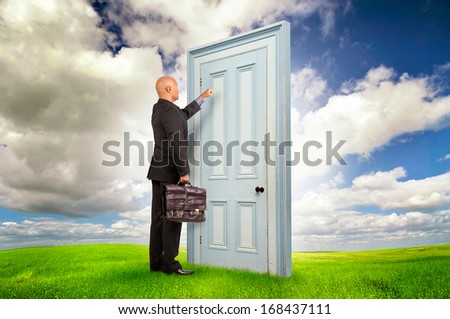 Businessman or salesman with briefcase knocking at a door outdoors