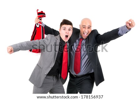 Happy businessman with football scarf celebrating a victory isolated in white