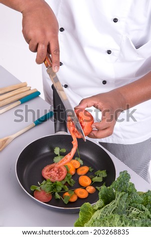 Male chef with fruits and vegetables cooking