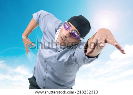 Businessman with swimming gear against the sky