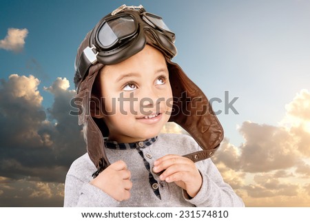 Young boy with pilot helmet isolated against the sky