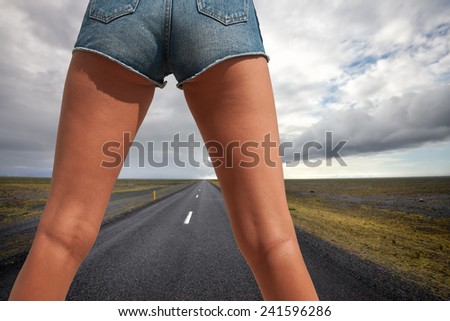 Woman\'s legs in the middle of an empty road in country side