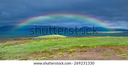 Beautiful river with rainbow just before the storm in Iceland