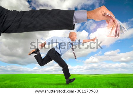 Businessman running with raised arms chasing money
