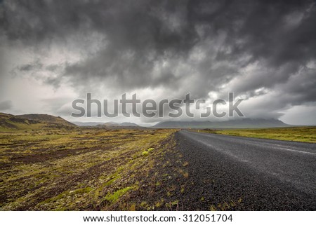 Empty road with cloudy skies in wild Iceland
