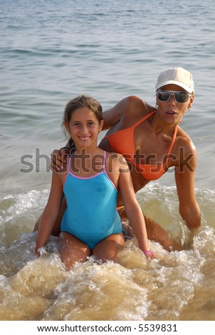 woman and girl in the beach posing