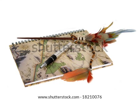Travel diary with a pen and feathers isolated against a white background