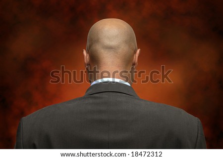 Businessman on is back with a dark background
