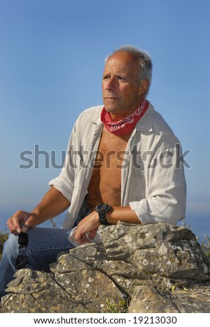 Handsome mature man adventurer posing outdoors