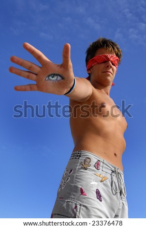 Blindfolded boy with an eye in is hand