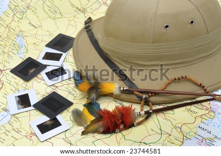 Explorer\'s hat and slides over map