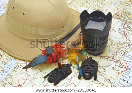 Explorer\'s hat and lenses over map
