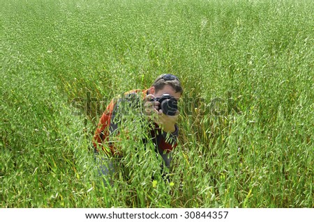 photographer hidden in the grass