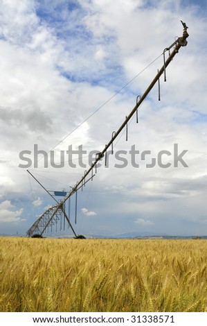 Agriculture watering machine with cloudy sky