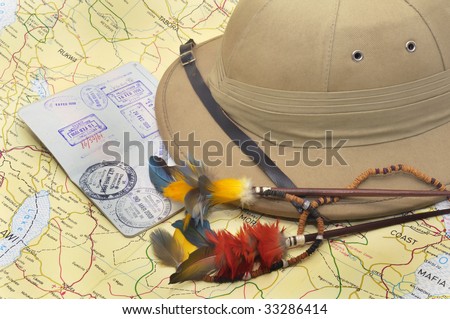 Explorer\'s hat and passport over map