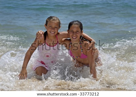 stock photo Two young girls in the beach having fun