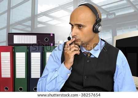 Thinking businessman with headset in the office isolated in white
