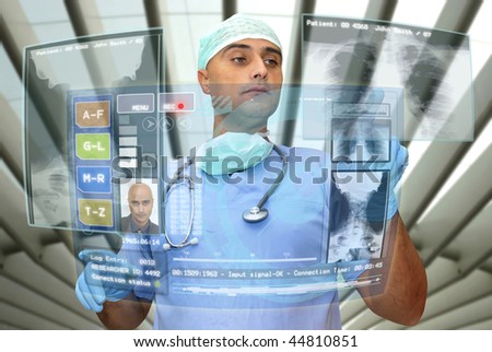 Doctor with hightech computer screen viewing patient data