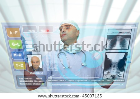 Doctor with hightech computer screen viewing patient data