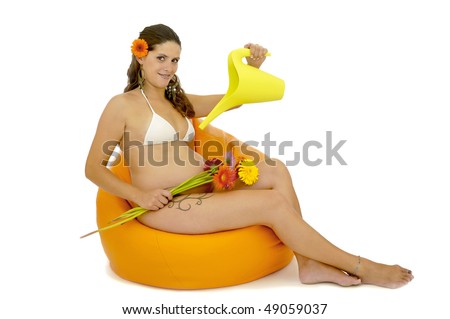 Pregnant woman with tattoo in bikini