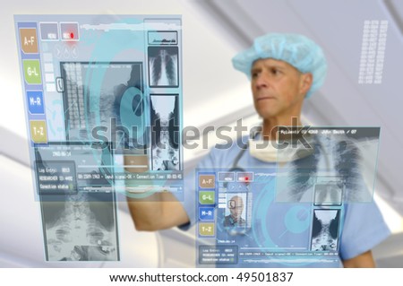 Doctor in uniform with high-tech screen in the hospital