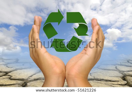 Hands with recycle symbol over a dry soil and sky background