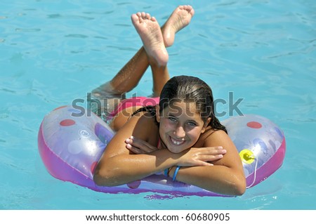 Beautiful girl posing in a swimming pool