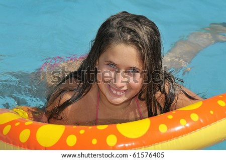 Beautiful girl posing in a swimming pool
