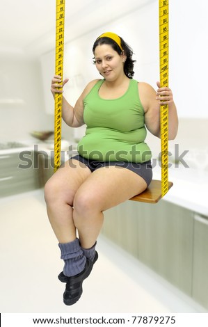 Large girl in a swing made of measuring tape