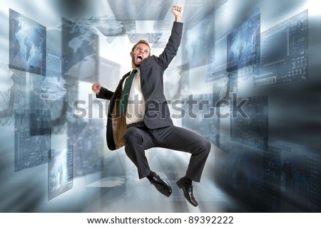 Young businessman jumping with digital screens all around