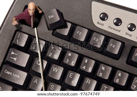 Businessman escaping from Escape key in a computer keyboard