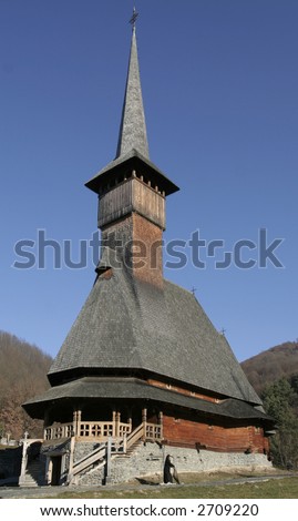 Wooden church and nun on a sunny day