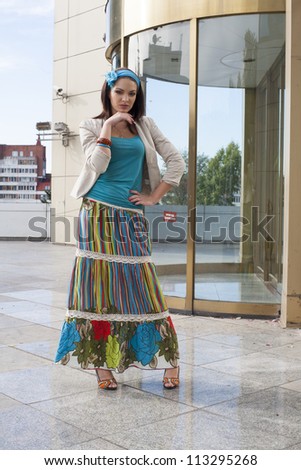 girl in a long skirt with colored storefront