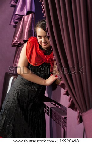 Brunette at the window with curtains