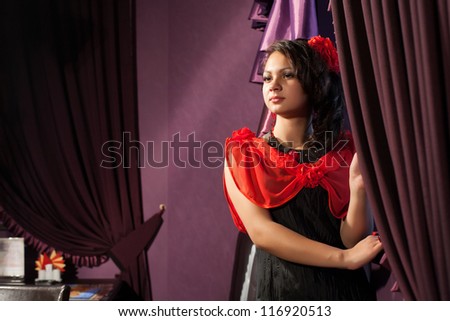 Brunette at the window with curtains