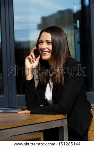 girl in the cafe talking on cell phone