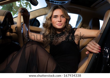 Beautiful blonde in an expensive car