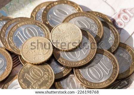 Coin worth ten cents on the euro coins against ten rubles