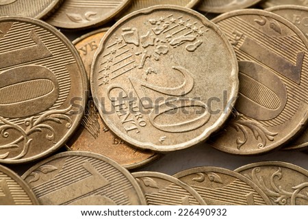Coin twenty euro cents coins on a background of ten rubles