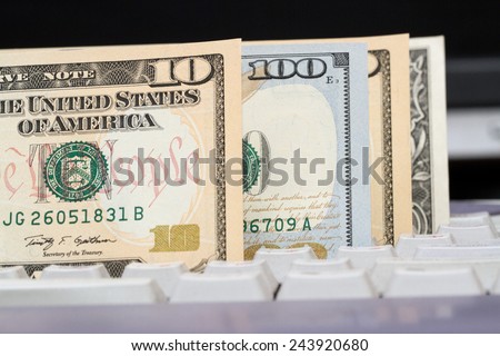 American dollars on a computer keyboard. The concept of electronic payments