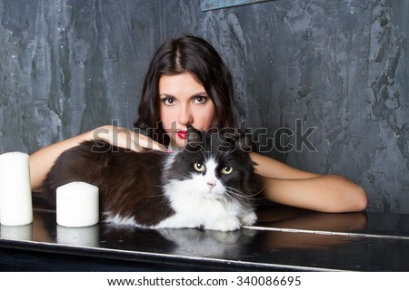 girl with a cat at the piano