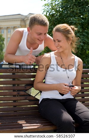 A pair of young people listen to music