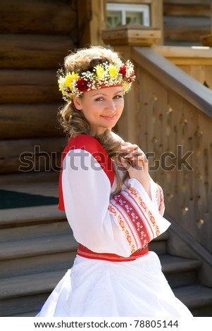 Bride in a white dress, styled as Russian folk costume