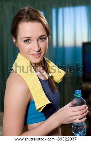 Young athlete drinks water