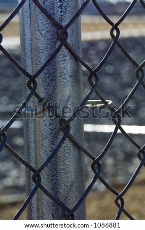 Chain-link fence attached to fence pole