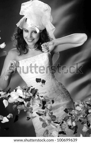 portrait of bride with rose petals on the background of fire